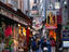 A narrow street filled with shops selling souvenirs to tourists on their way to Mont Saint Michel - Normandy