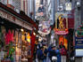 A narrow street filled with shops selling souvenirs to tourists on their way to Mont Saint Michel - Normandy