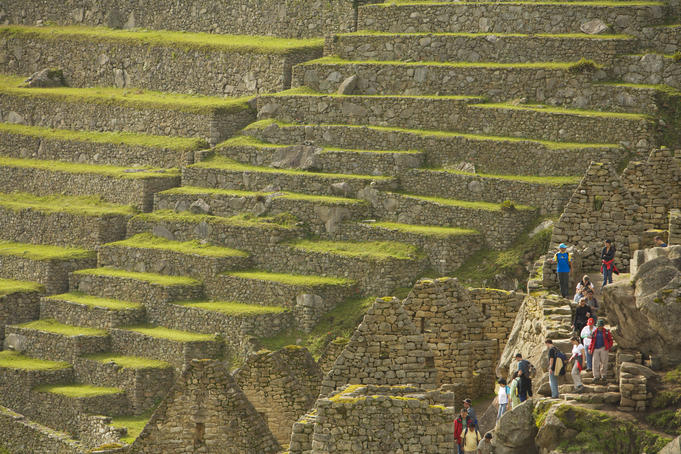 Tourists explore the stone ruins of Machu Picchu
