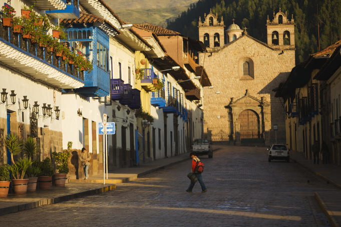 Person walks through quiet morning streets in Cusco.