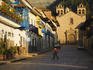 Person walks through quiet morning streets in Cusco.