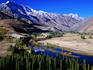 Gilgit River cutting through the cultivated valley with mountains in the background, Phander.