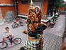 Young boys riding their bicycles outside a temple.