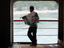 Man reading a newspaper on the Bali-Lombok ferry.