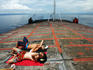 Tourists sunbathing on the deck of the Bali-Lombok ferry.