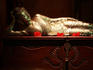 Golden statue of reclining Buddha.