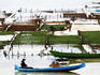 Seaweed farmers tending their farms on the sea.