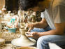 Potter making pottery bowls on a potter's wheel at Kageyama Pottery.
