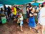 Overview of Parap Outdoor Market: people leaving a covered stall - Darwin, Northern Territory