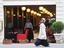 Muslim woman passes by modern snack-bar, Beyoglu district.