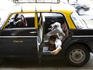 Taxi driver takes a nap in his vehicle.