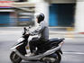 Scooter rider zooming through the city.