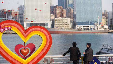 Two businessman standing by Love River near Fishermans Wharf.