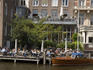 Patrons sit along Kloveniersburgwal canal at Cafe De Jaren in central Amsterdam.