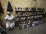 Shoe salesman reads the paper, Medina.