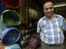 Salesman standing in front of his shop on Tala Kebira.