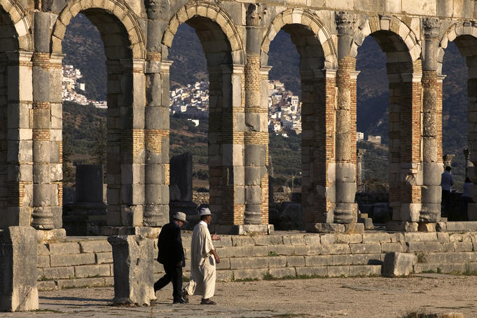 Men visit the remains of the Roman city of Volubilis.