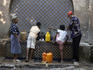 People collect water from Demnati Fountain.