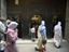 People walk by Kairaouine Mosque, Fès
