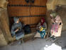 Women sit on doorstep to Kairouine Mosque.