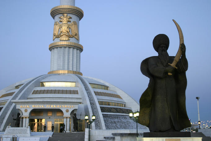 Statue in front of monument to Independece of Turkmenistan.