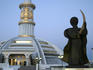 Statue in front of monument to Independece of Turkmenistan.