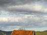 Cottage ruin in barren countryside.