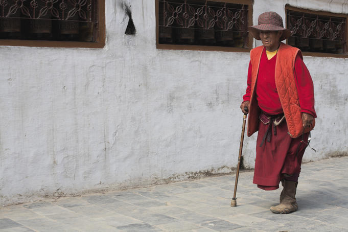 Woman with walking stick, Bodhnath Buddhist stupa.