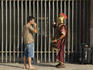 Man in gladiator costume at Colosseum taking a drink break.