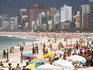 People enjoying the beach and surf at Ipanema Beach.