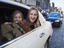 Girls hanging out of limousine window on Royal Mile.