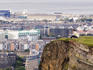 Person sitting at top of Salisbury Crags, Holyrood Park.