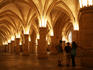 Visitors in Salle des Gens d'Arms (Hall of the Men-at-Arms), part of La Conciergerie, a historical royal palace and prison.