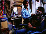 Street barber in Khari Baoli or Spice Market, Old Delhi.