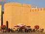 People sitting outside at cafe by ancient city walls, Moulay Assan Square, Essaouira