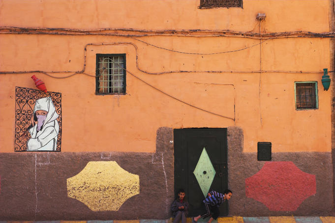 Boys playing in front of house, Old City, Marrakesh Medina.