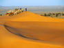 Tuareg nomads with camels in sand dunes of Sahara Desert, Arakou.