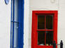 Red and blue painted borders around some windows downtown.