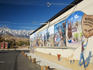 Mural on walls of Beverly and Jim Rogers Museum of Lone Pine Film History, Owens Valley, with Sierra Nevada in distance.