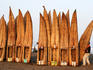 A man specially employed to lift Caballitos de Totora (small reed boats) carrying a fishermans craft to the waters edge, Lambayeque