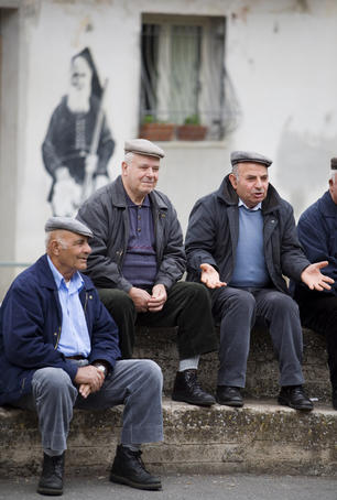 Men from the village gathered to discuss the day's events.
