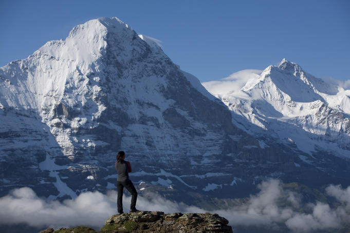 Climber looks across to the notorious north wall of Eiger Mountain.