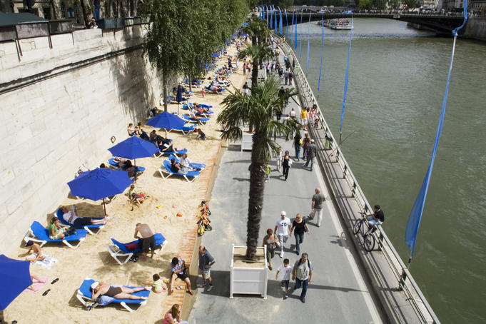 Sunbathers on banks of River Siene at the Paris Plage (Paris beach).