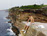 Young man sitting on edge of cliff at Vaucluse.