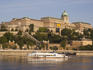 Castle Hill with cruise boat sailing down the Danube River.