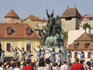 Teenage girls on stage performing at outdoor dance show in front of Eger Castle and statue of Istvan Dobo.