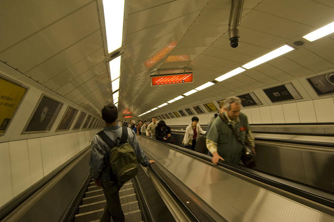 People riding on escalator in the Budapest Metro.