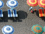 Bright beach umbrellas and chairs on black sand, Amalfi Coast.
