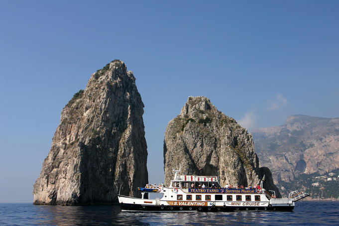 Ferry sailing past I Faraglioni, Island of Capri.