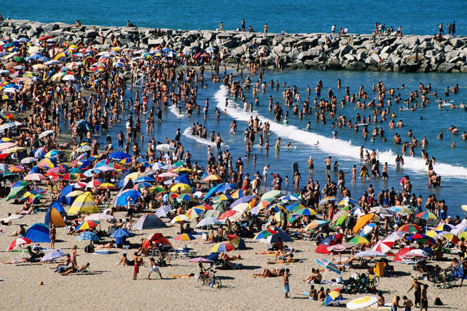 Multitude of swimmers and sunbathers at Playa Varese.